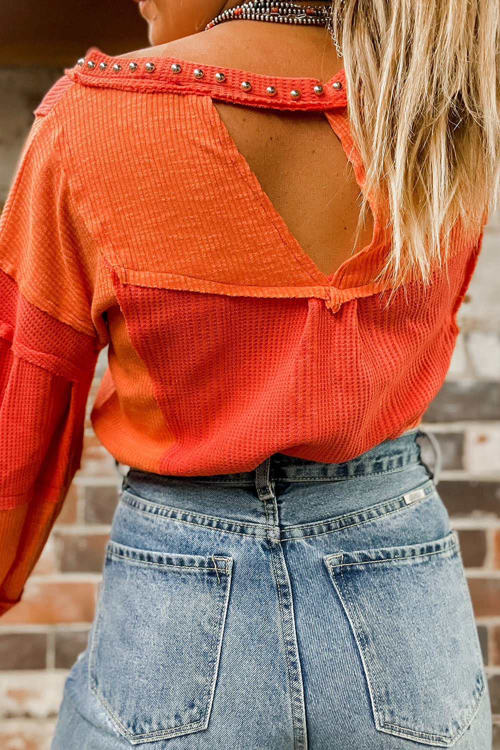 Fiery Red Studded V Neckline Exposed Seam Textured Knit Top